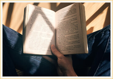 Picture of a book with a smiling woman holding it